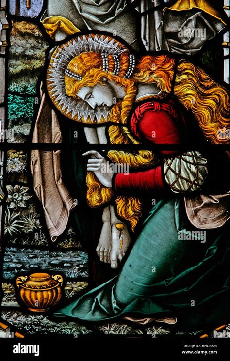 Stained glass window depicting Mary Magdalene kneeling at the foot of ...