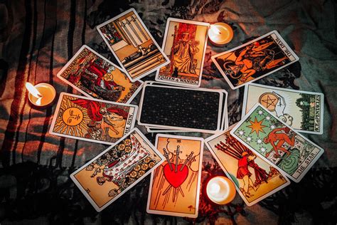 Tarot reading with tarot card background and candlelight on the table ...