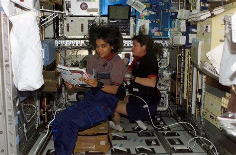 Astronauts Kalpana Chawla and Laurel Clark, STS-107 mission specialists, work in the SPACEHAB ...