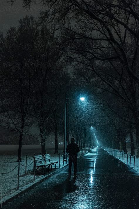 "Man On A Snowy Path At Night" by Stocksy Contributor "CWP, LLC" - Stocksy