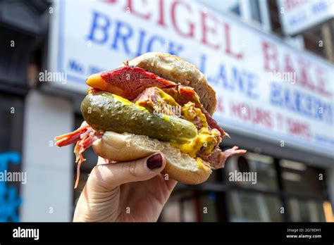 Famous salt beef bagel with mustard and pickle at Beigel Bake, Brick Lane, London, UK Stock ...