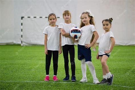 Premium Photo | Children playing football indoors football team contains four girls