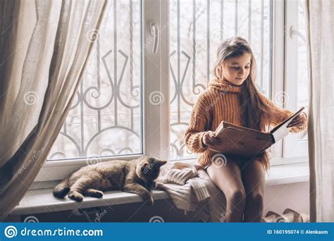 Child Reading a Book with Cat Stock Photo - Image of indoors, owner: 160195074