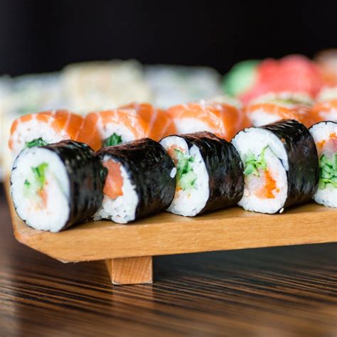 Sushi rolls served on a wooden plate - Ghost Influence