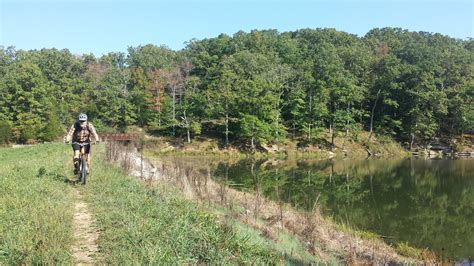 W riding along Crooked Creek Lake Dam at the end of the Crooked Creek Trail.