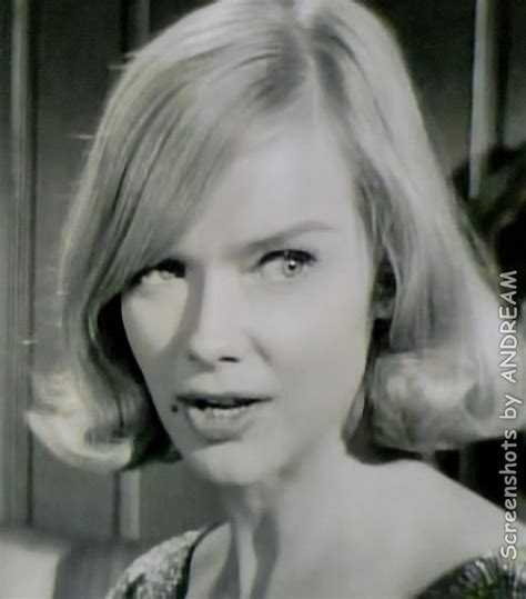 a woman with blonde hair is looking at the camera