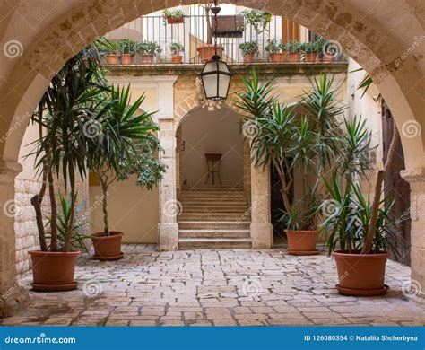 Backyard with Arch, Plants in Pots, Stairs and Lantern. Patio Decoration. Ancient Courtyard ...