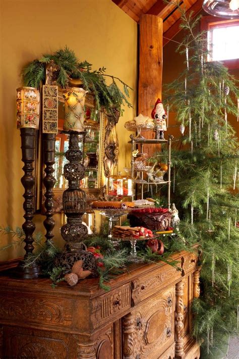 a christmas tree sitting on top of a wooden table next to a dresser covered in ornaments