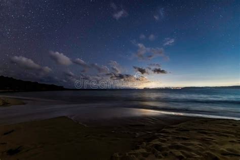 The Night Sky at the Beach and the City Lights in the Distance Stock ...