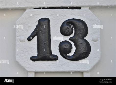 A house number plaque, showing the number thirteen (13 Stock Photo - Alamy