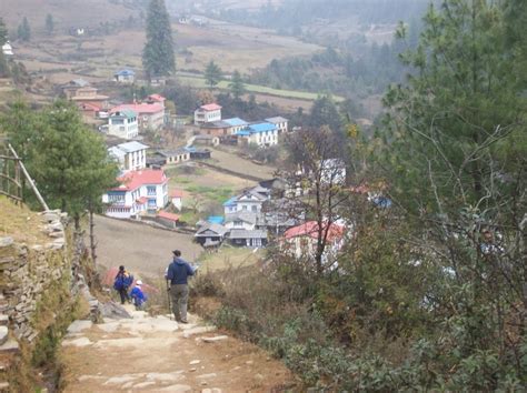 Hiking into Junbesi Nepal on the way to Basa village to deliver parts for a hydroelectric system ...