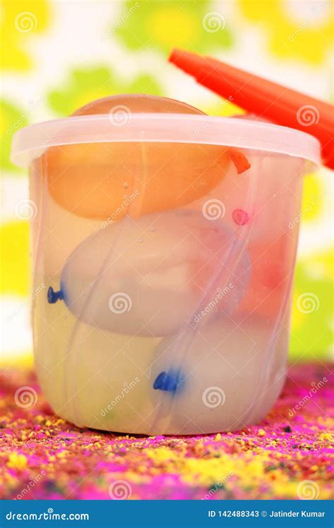 Picture of Colorful Water Balloons in Bucket with Pichkari for Holi Fun Stock Image - Image of ...