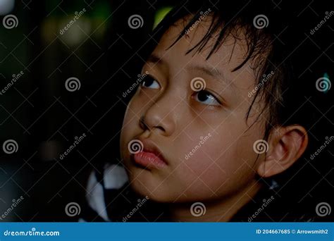 Sad Little Child Girl Sitting Alone in Dark Room.Low Key Style Stock ...