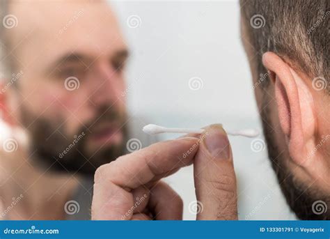 Man Removing Wax from Ear Using Q-tip Stock Image - Image of clean ...