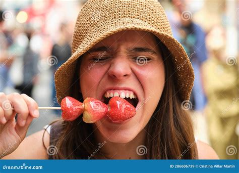 Tourist Woman Eating Candied Strawberries on a Stick in Tokyo, Japan ...