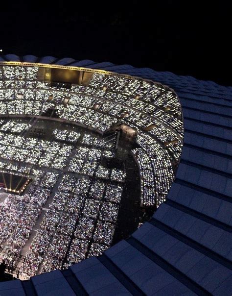 an aerial view of a stadium at night with lights on the roof and in the ...