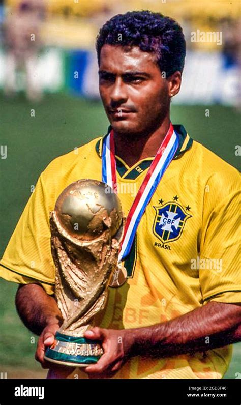 Brazilian super star Romario holds the 1994 World Cup trophy after ...