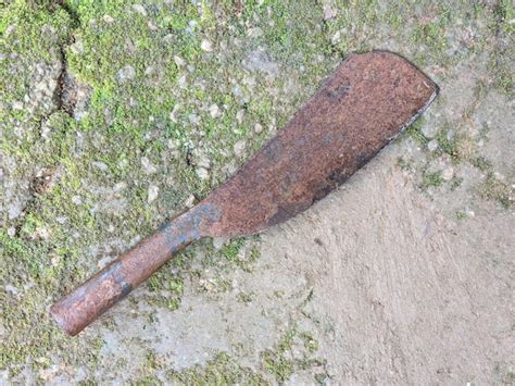 Premium Photo | An old rusty machete on the ground