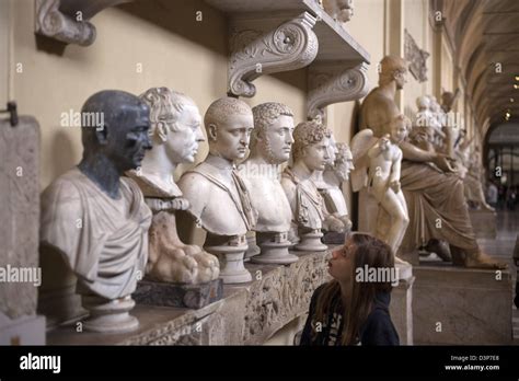 Classical Roman sculpture galleries at the Vatican museum in Rome showing gods and emperors ...