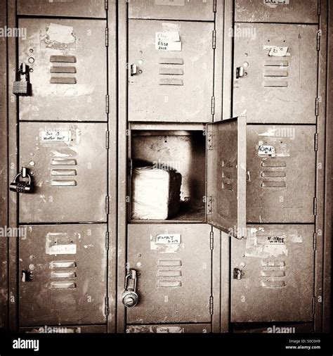 Old metal one square foot school lockers locked except one door opened with block inside Stock ...