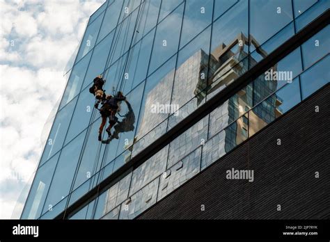 Workers cleaning office building windows Stock Photo - Alamy