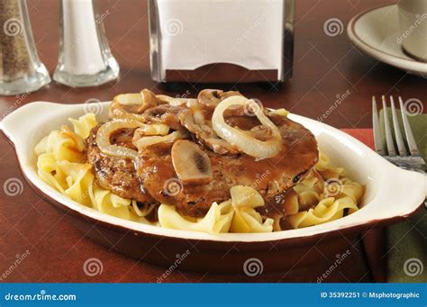 Salisbury steak on noodles stock image. Image of table - 35392251