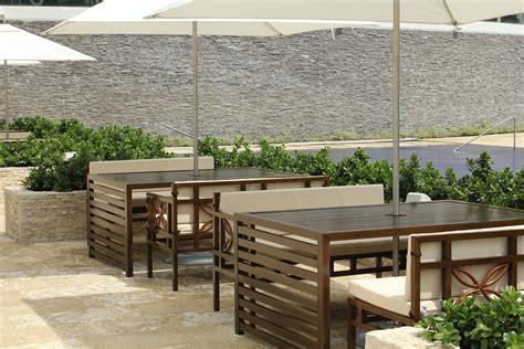 an outdoor dining area with tables and umbrellas