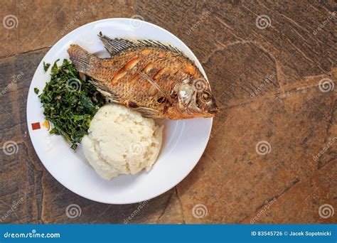 Traditional African Food - Ugali, Fish and Greens Stock Photo - Image ...