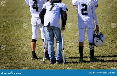 Injured Football Player on Sidelines with Crutches with Team Stock ...