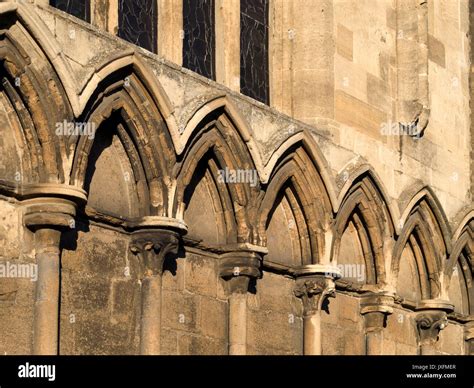 Row of old, stone pointed Gothic arches decorating exterior wall of All Saints Church, Stamford ...