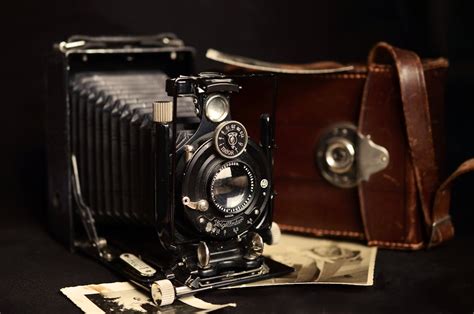 Black Classic Camera Near Brown Leather Bag · Free Stock Photo