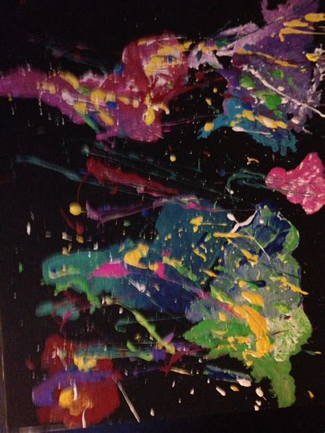 an abstract painting with lots of colors and sprinkles on black paper,