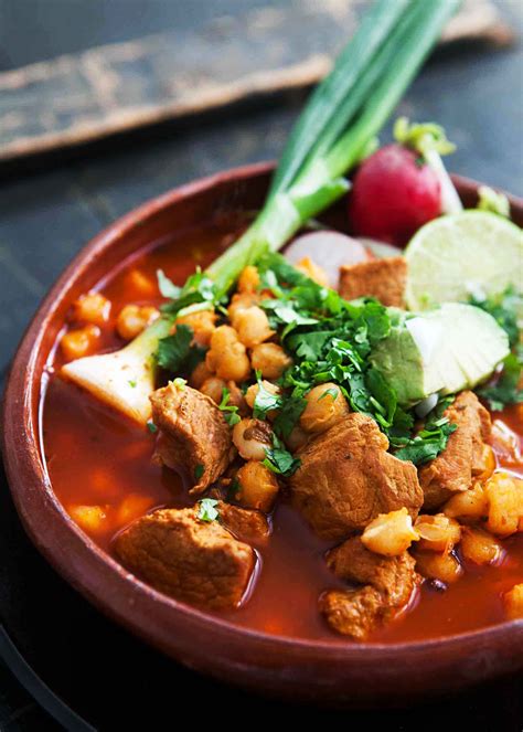 a bowl filled with meat and vegetables on top of a table