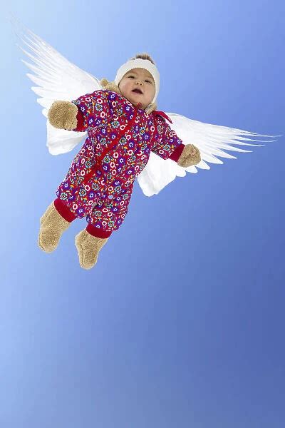 Baby girl with wings, flying angel. model released