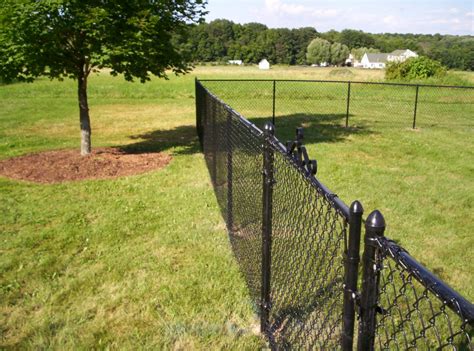 An all black chain link fence looks great in every season. It blends ...
