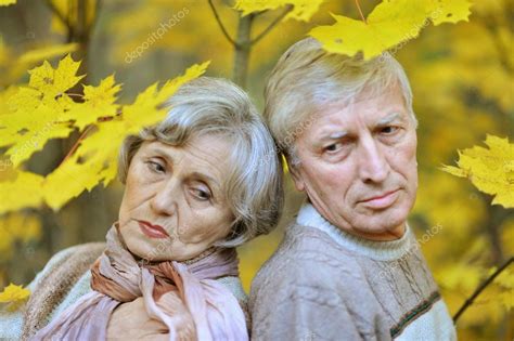 Sad old couple posing at autumn park — Stock Photo © aletia #53027847