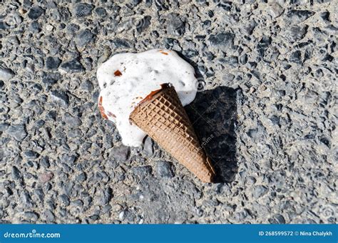 Melted Ice Cream on Sidewalk on Hot Summer Day. Ice Cream in Cone Fell ...