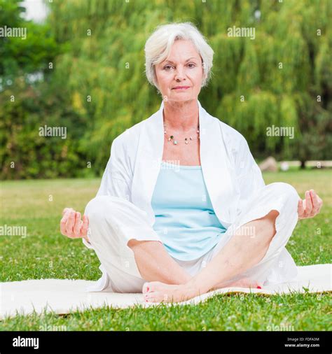 senior healthy old woman practicing yoga and tai chi outdoor Stock ...