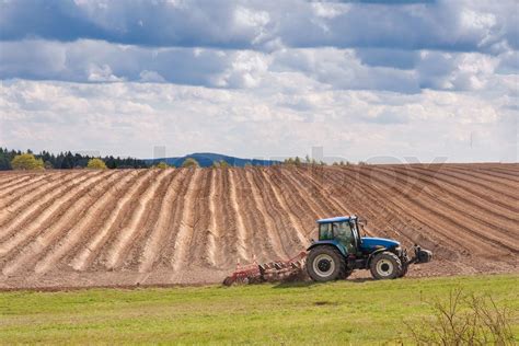 tractor planting potatoes in the springtime | Stock image | Colourbox