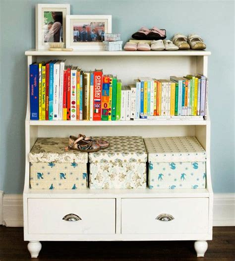 a bookshelf filled with lots of books next to a white dresser topped ...