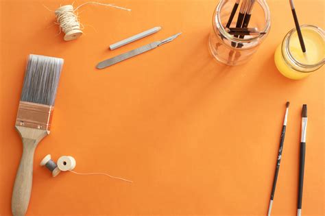 Free Stock Photo 12128 Art Supplies and Paintbrushes on Orange Surface | freeimageslive