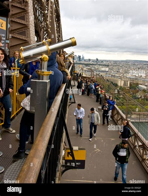 Eiffel tower observation deck with viewing telescope and tourists Paris ...