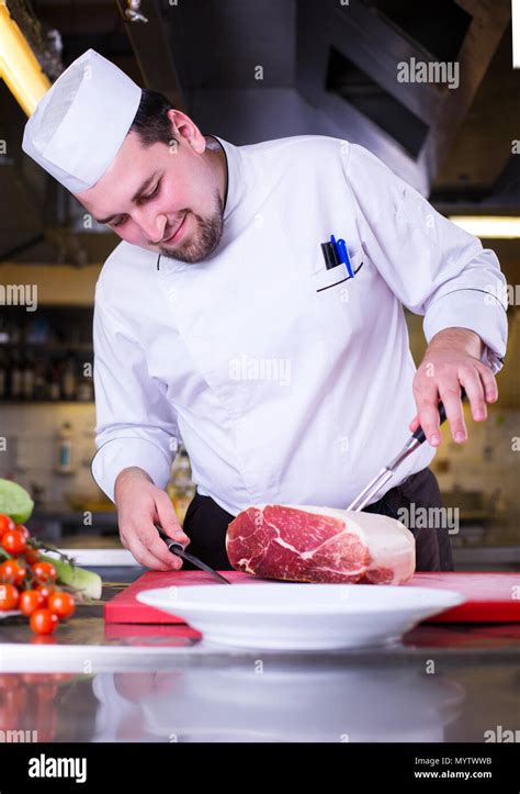 Chef cutting big piece of meat Stock Photo - Alamy