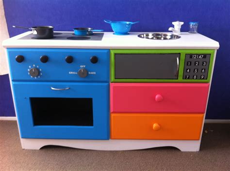 a multicolored wooden toy stove and oven