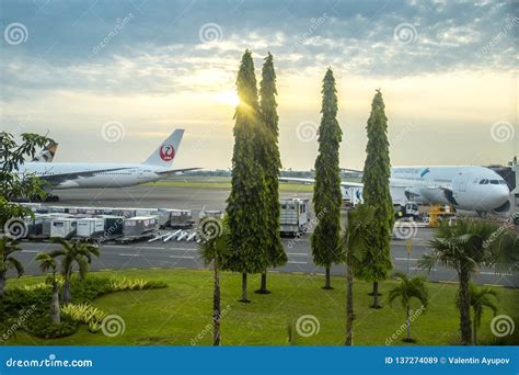 Aircraft at Ngurah Rai Airport in Bali Airport Runway at Sunset Time. Bali, Indonesia. January ...