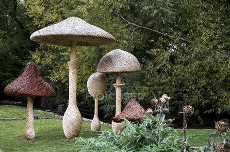 Tall wooden carved toadstools garden sculptures in Oxfordshire, England — great milton, autumn ...