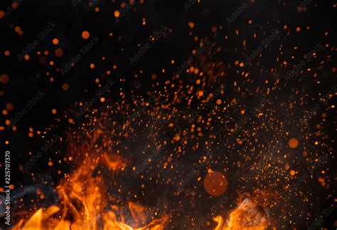 Fire sparks with flames on black background Stock Photo | Adobe Stock