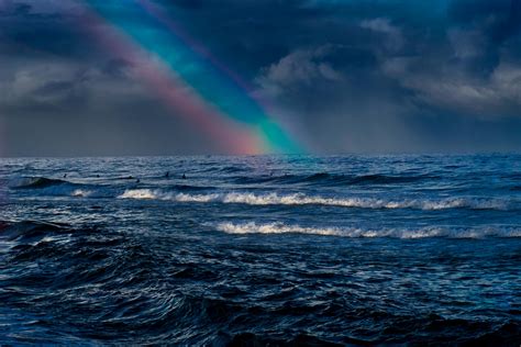 Ocean Waves Under Rainbow and Cloudy Sky · Free Stock Photo