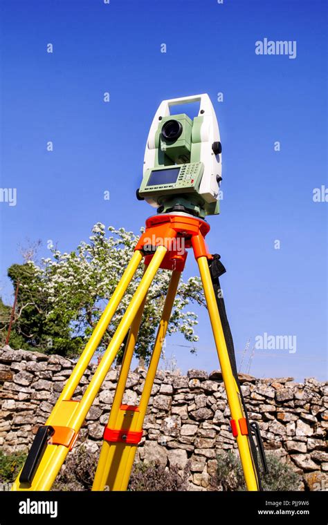 Total station. Survey Instrument geodetic device, total station set in the field. Total station ...