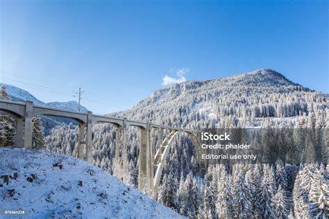 Train Viaduct Langwies In Switzerland In Sunshine Winter Snow Blue Sky Stock Photo - Download ...